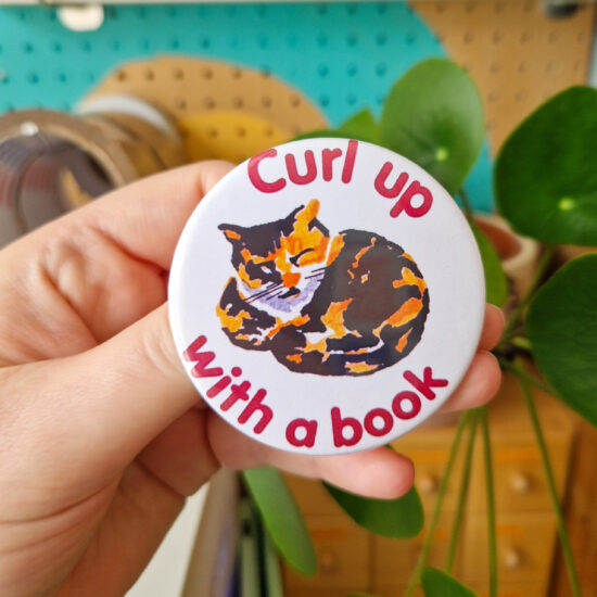 2024-06-07 13.05.22 Curl Up With A Book badge (cat edition)